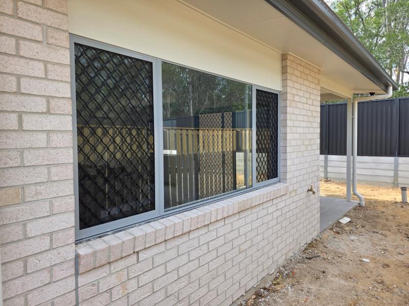 Barrier screen installation Fixed barrier screens on sliding windows