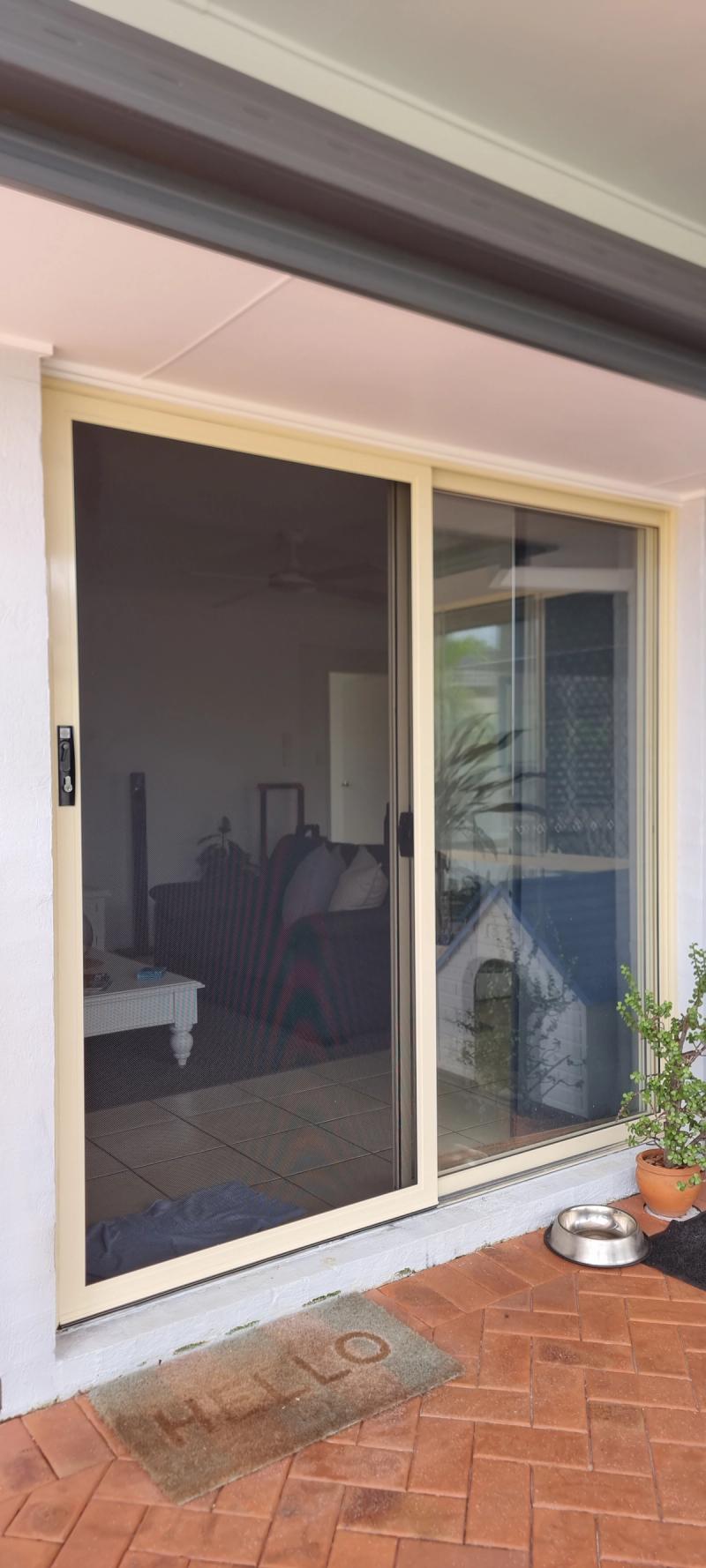 Security door screen installation Sliding security screen door in lounge room