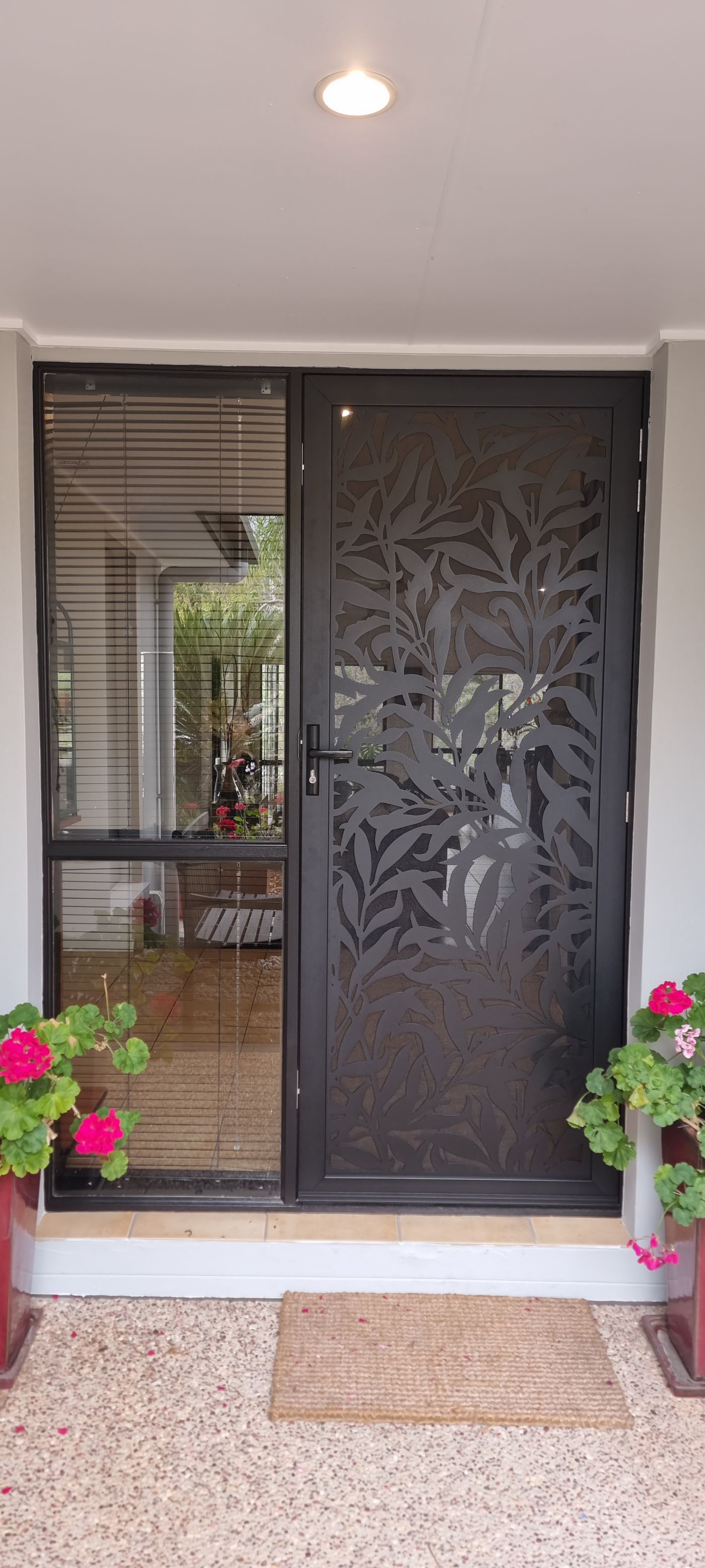 Hinged security screen door on a front entry