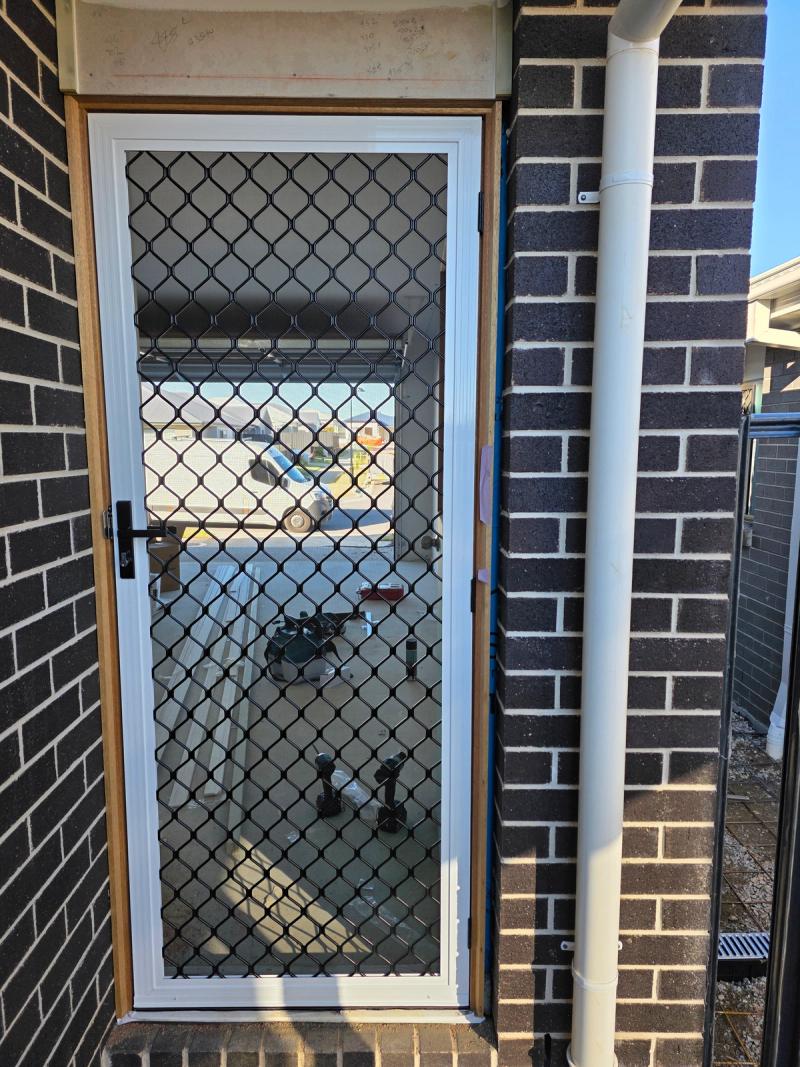 Barrier door screen close-up showing reinforced aluminium mesh detail