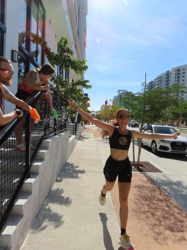 A runner returns to Revv Hollywood along the sidewalk after the group run.