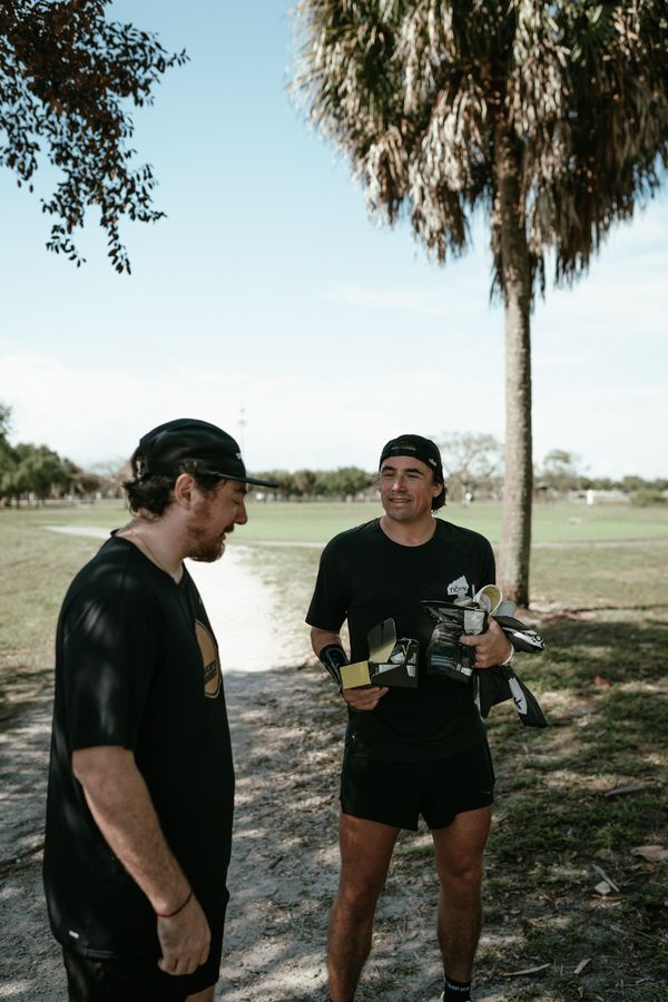 Two runners talk while holding snacks and water at Vista View Park.