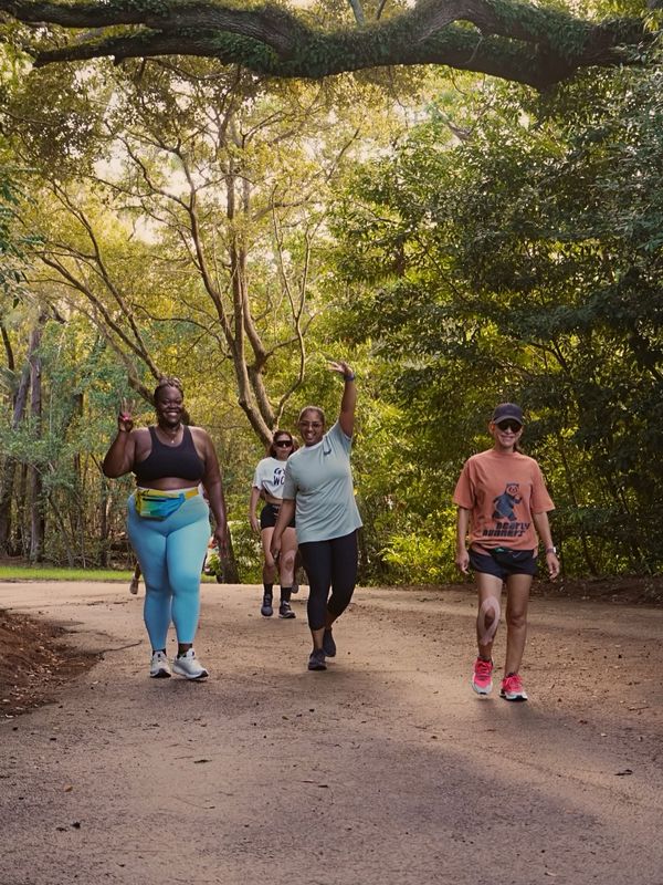 Runners share a shaded park path during Roots Fly High.