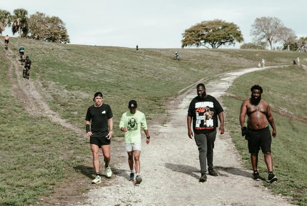 Runners walk along a path between the Vista View Park hills.