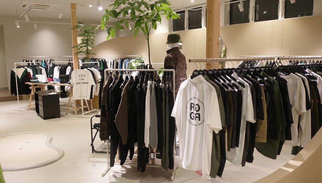 Inside RUFFLOG Kanazawa — golf apparel on racks with an indoor putting mat