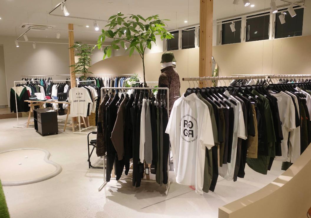Inside RUFFLOG Kanazawa — golf apparel on racks with an indoor putting mat
