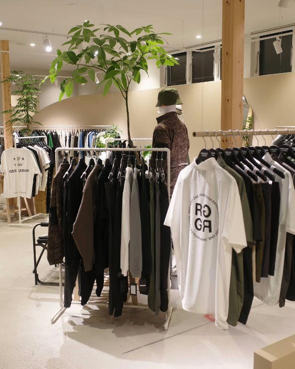 Inside RUFFLOG Kanazawa — golf apparel on racks with an indoor putting mat