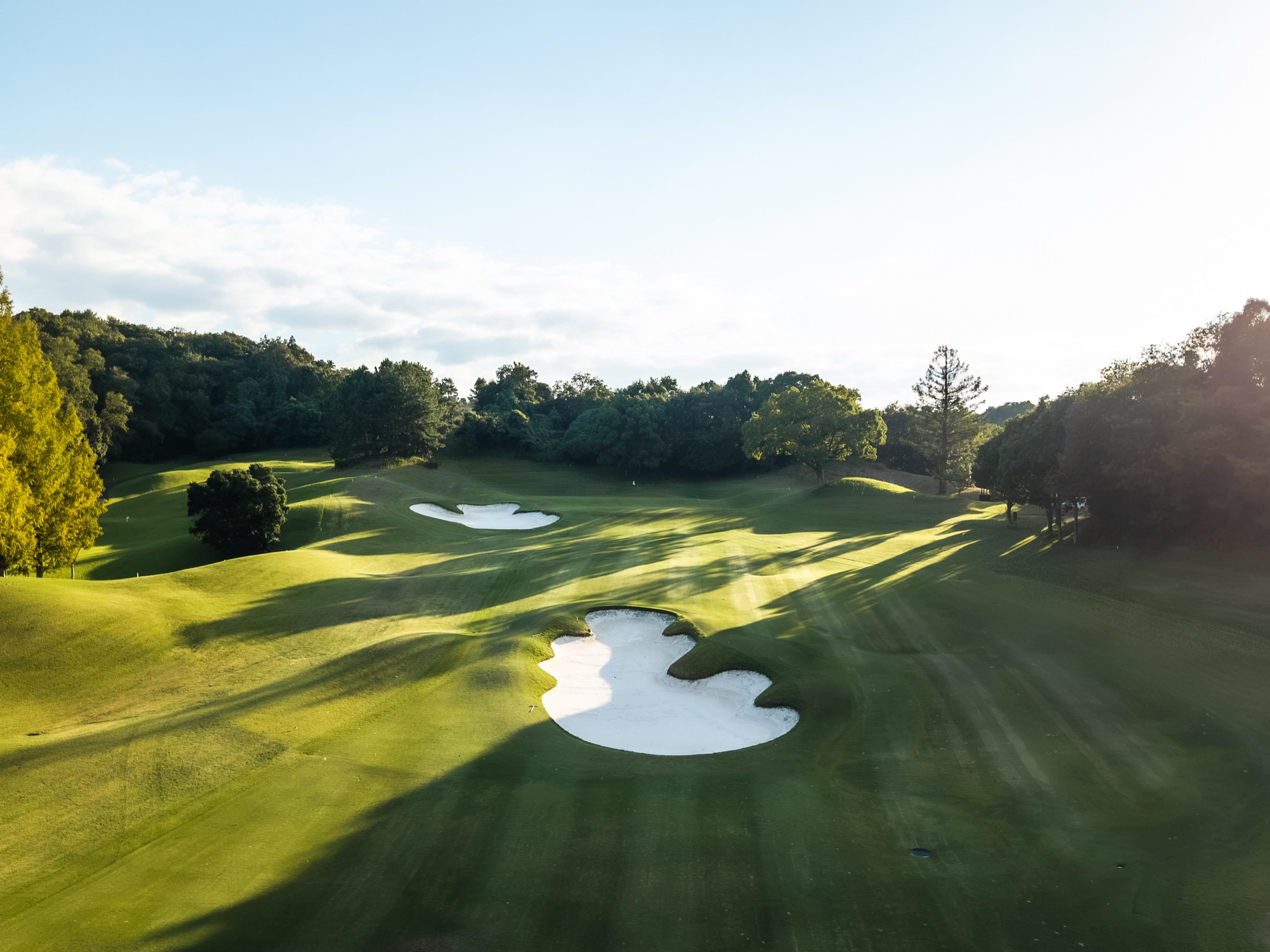 A fairway bunker in low sunlight