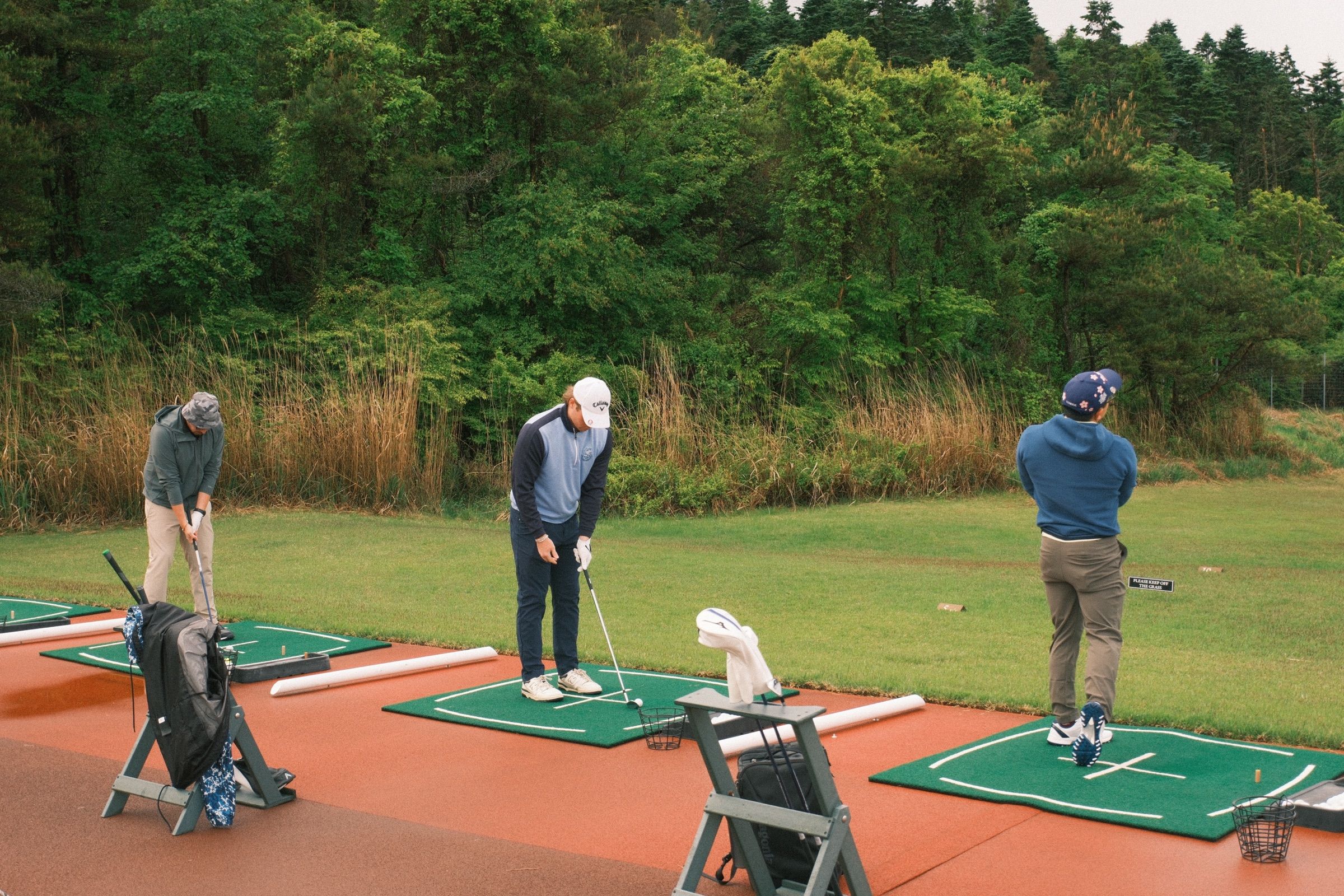 Guests warming up on the driving range at Fuji Classic under a grey May sky