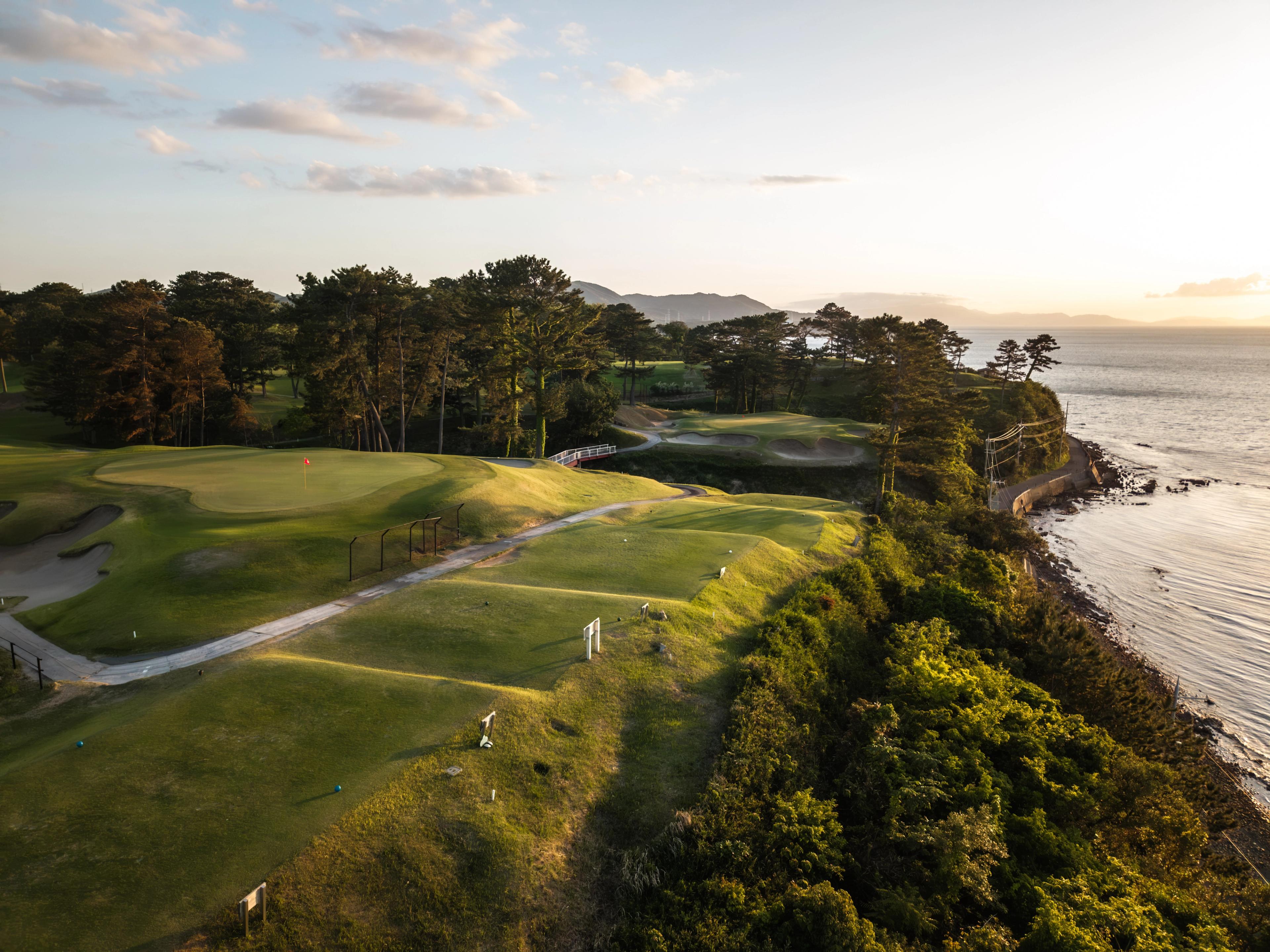 photo of osaka golf club during sunset by ocean