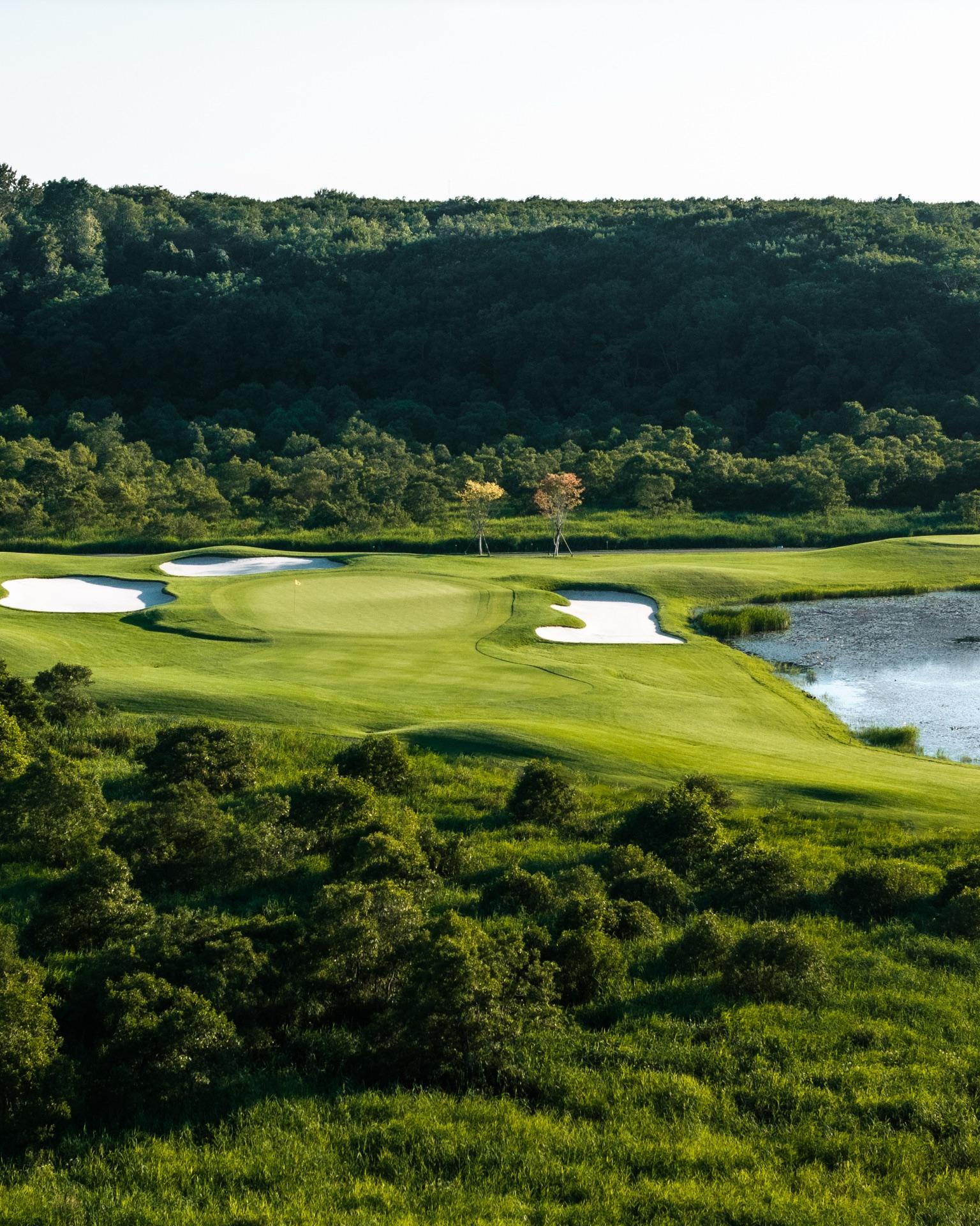 Hokkaido Brooks Country Club — green and pond from the air, Tomakomai