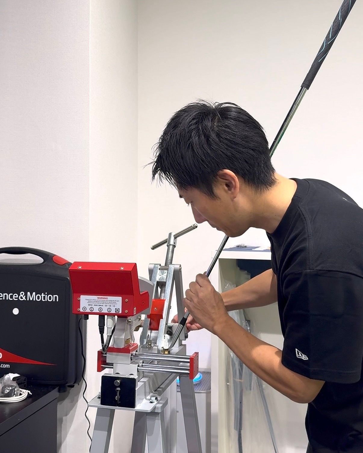A club being adjusted on a loft and lie machine