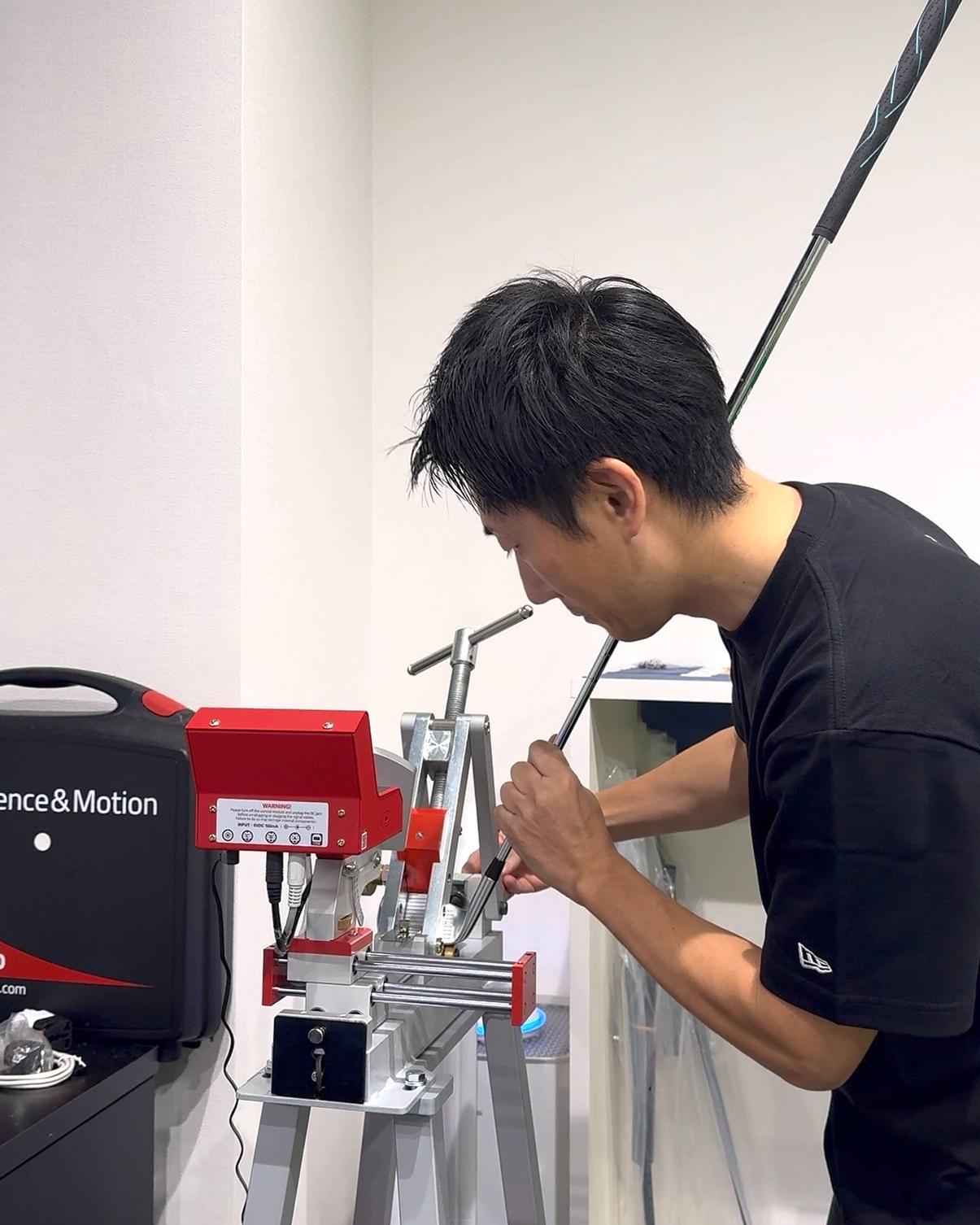 A club being adjusted on a loft and lie machine