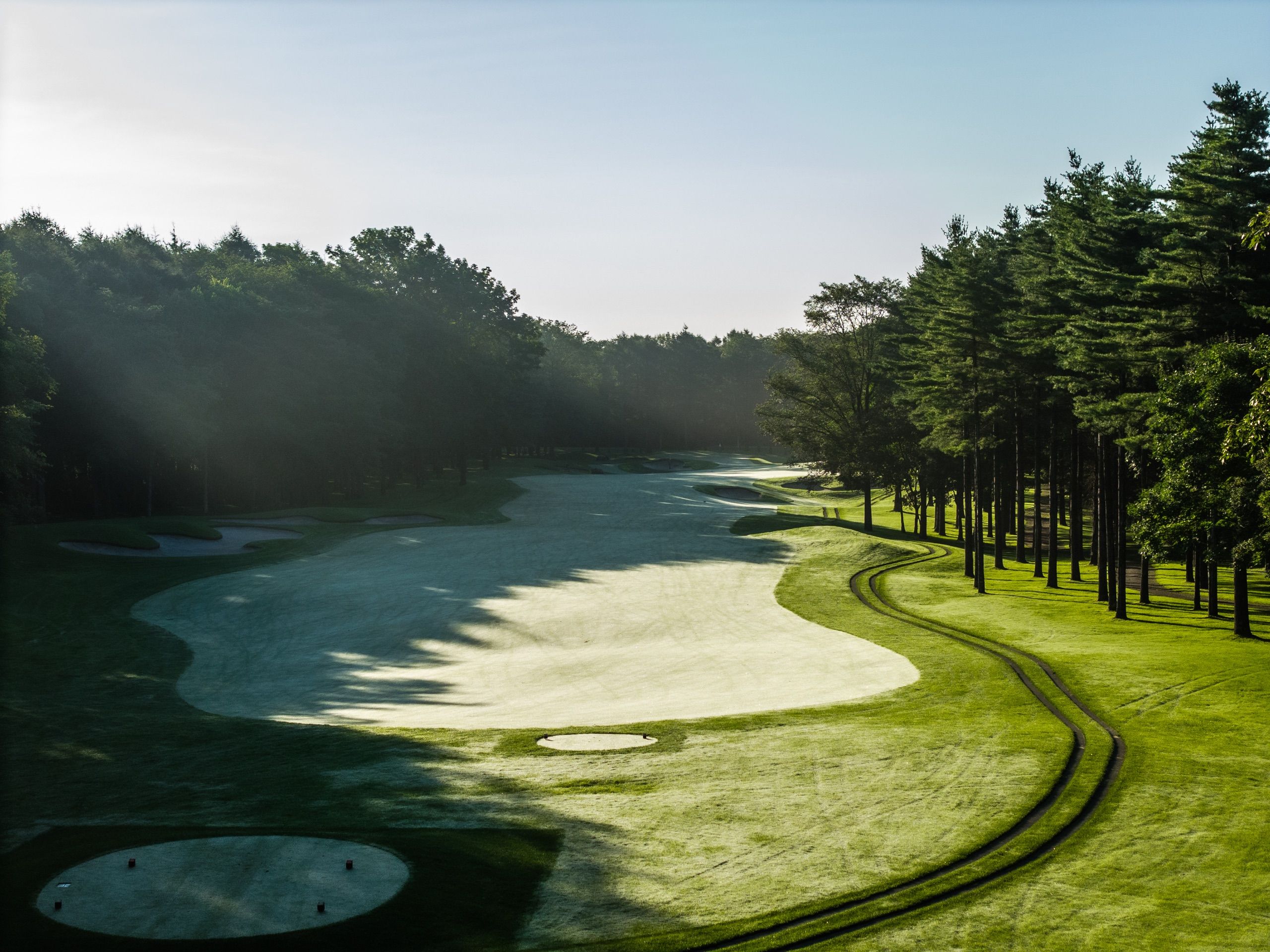 Katsura Golf Club — morning mist over a bunkered green framed by pines