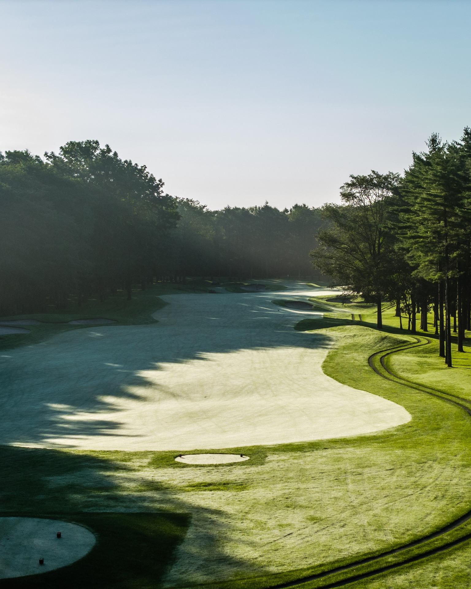 Katsura Golf Club — morning mist over a bunkered green framed by pines