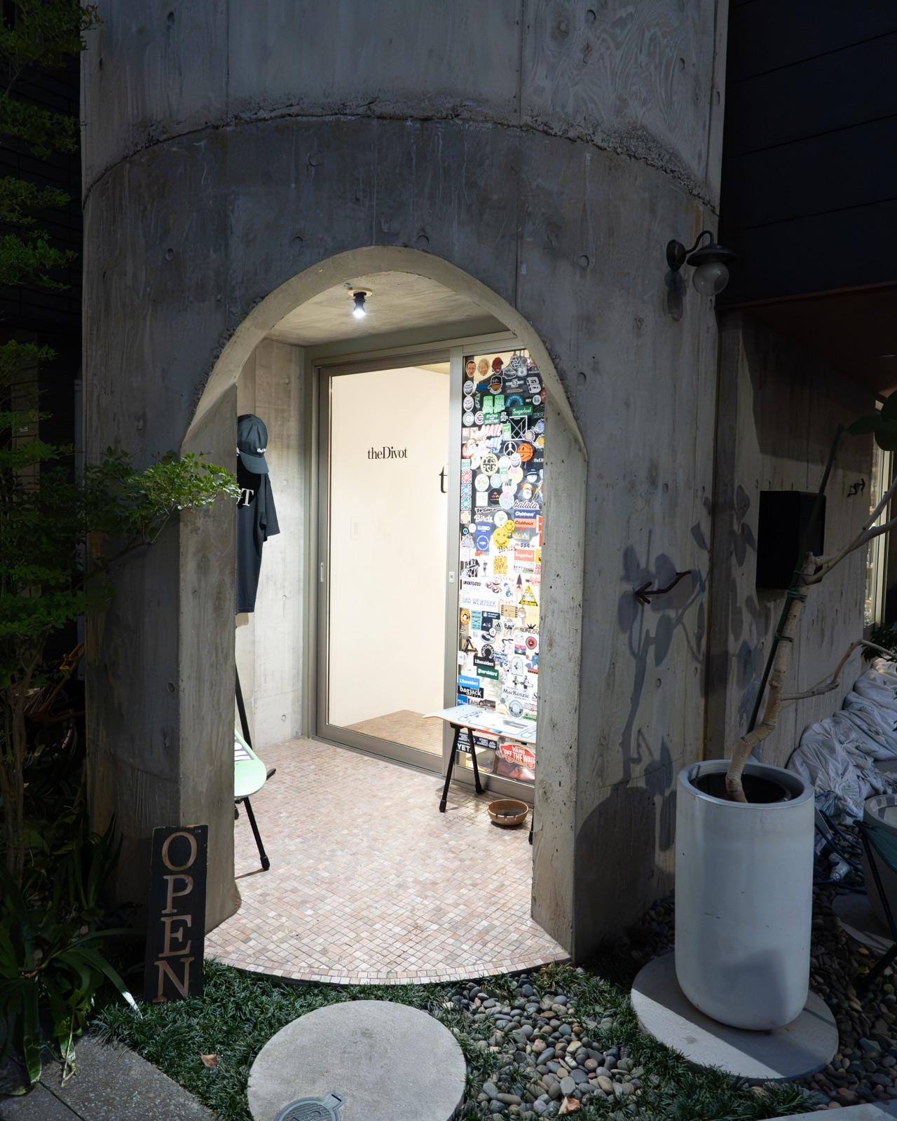 the Divot STORE exterior — the concrete arched entrance and OPEN flag in Sendagaya, Tokyo