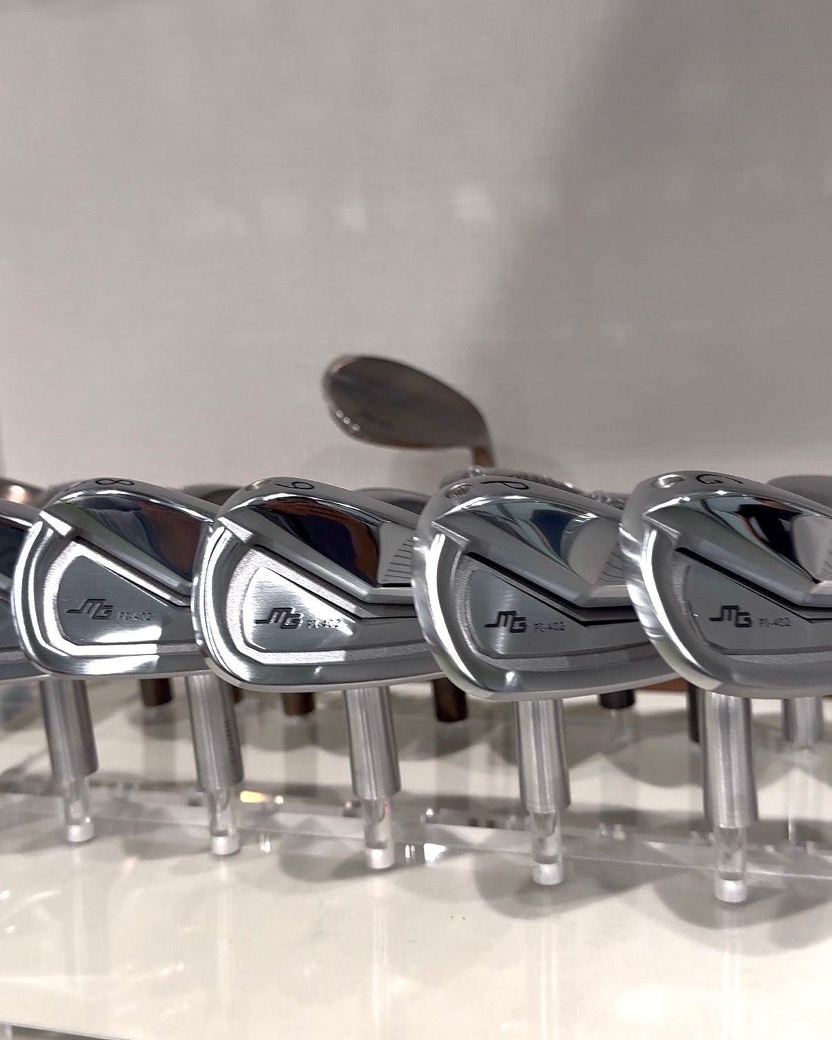 A row of Miura iron heads on display