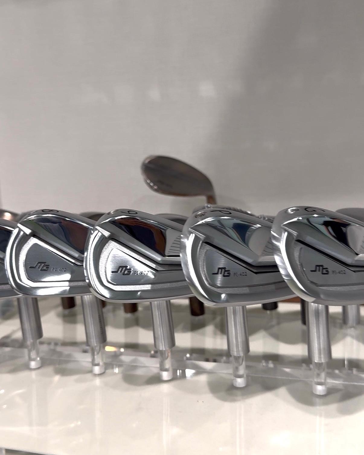 A row of Miura iron heads on display