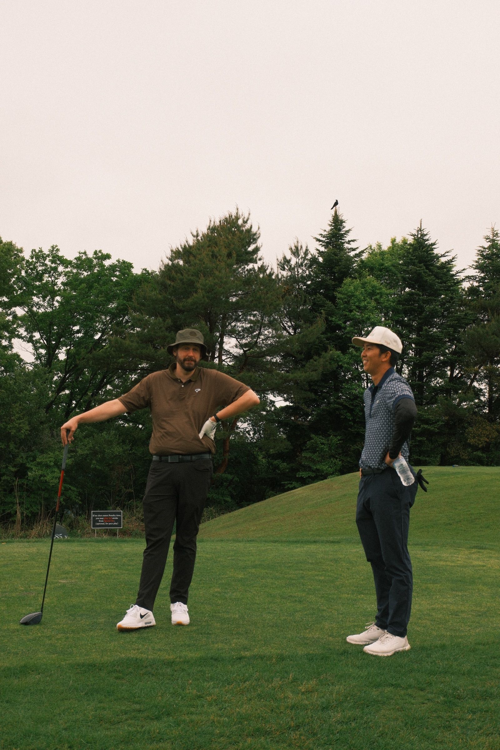 Two guests sizing up the opening tee shot