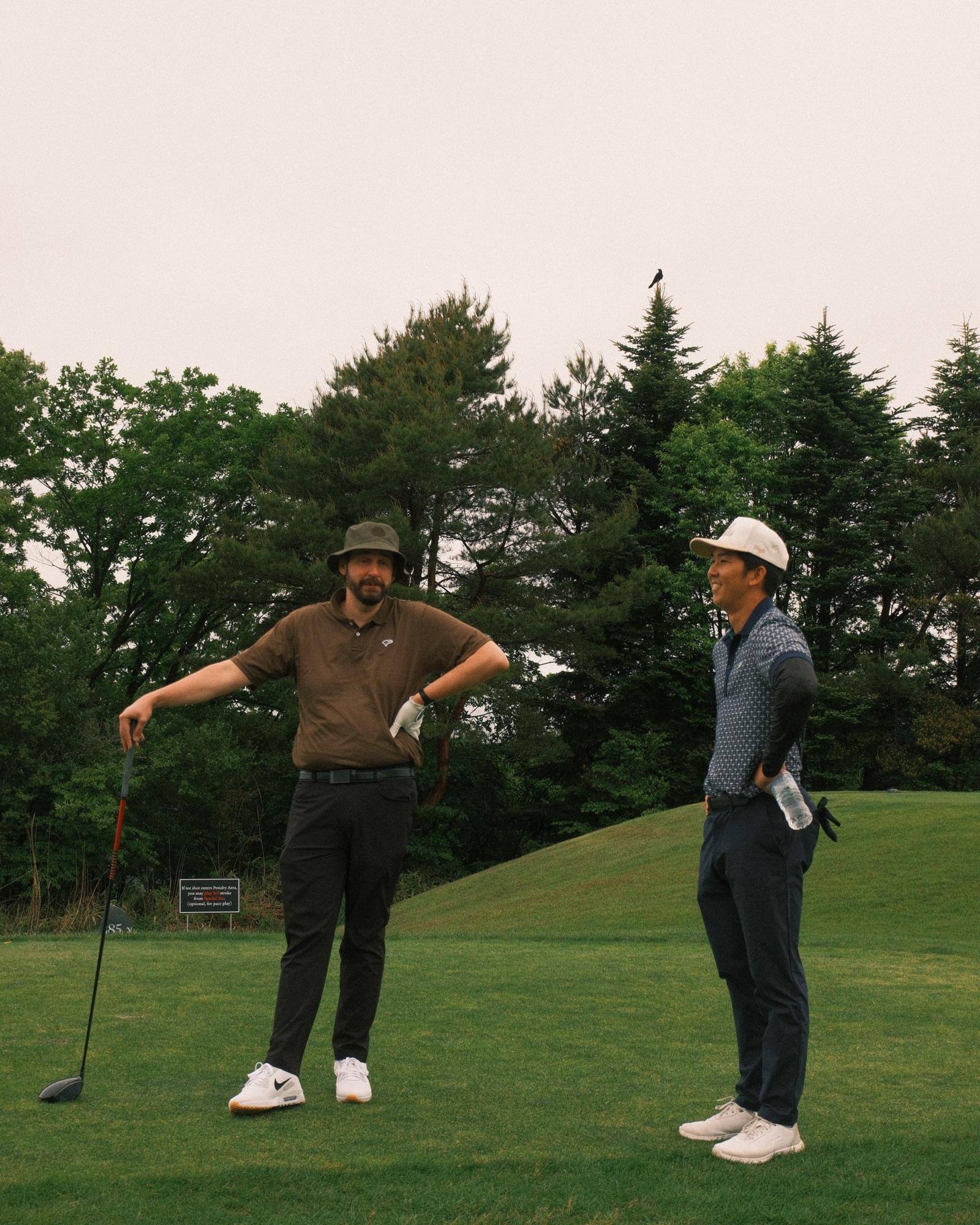 Two guests sizing up the opening tee shot