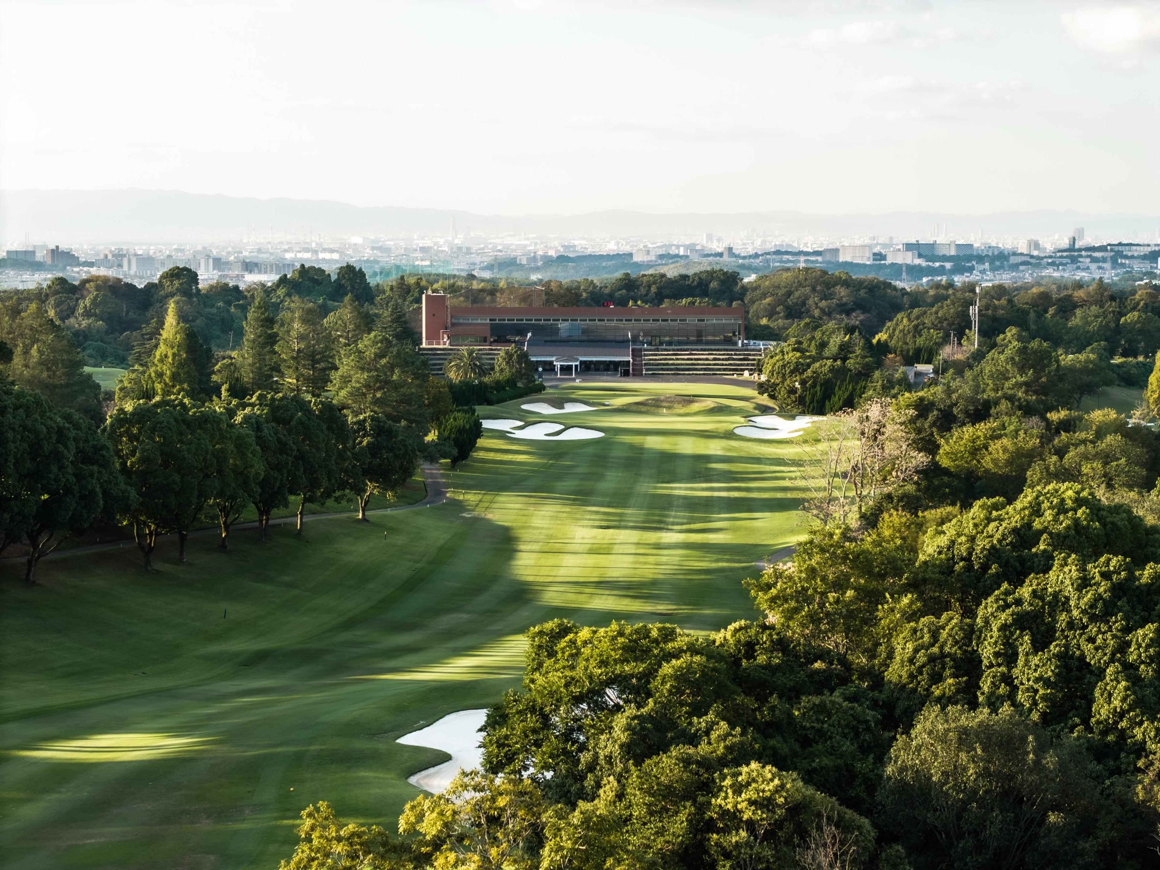 The 18th fairway running up to the clubhouse, Osaka beyond