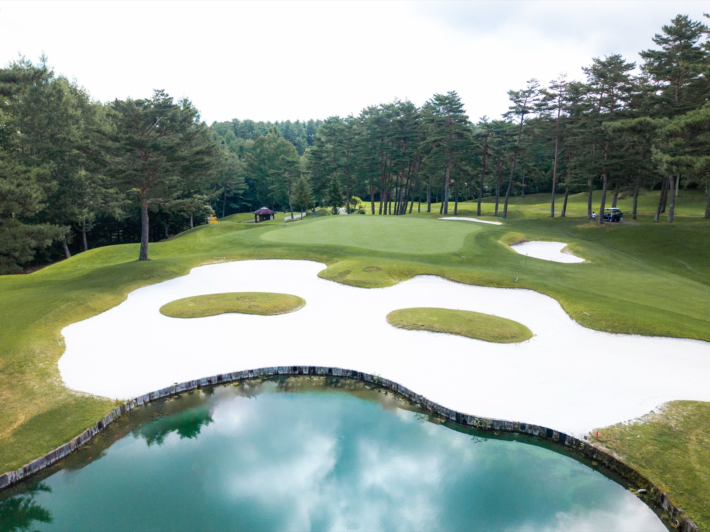 Green guarded by a large bunker and water