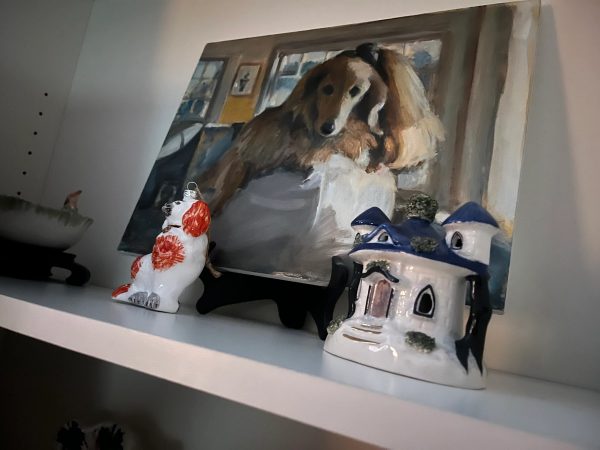 Jane’s painting of a spaniel, propped on a shelf among ornaments.