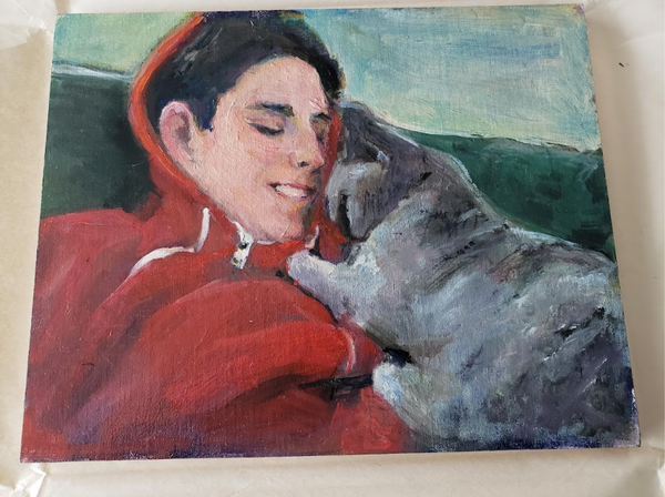 Jane’s painting of a young person in a red hoodie nuzzling their cat.