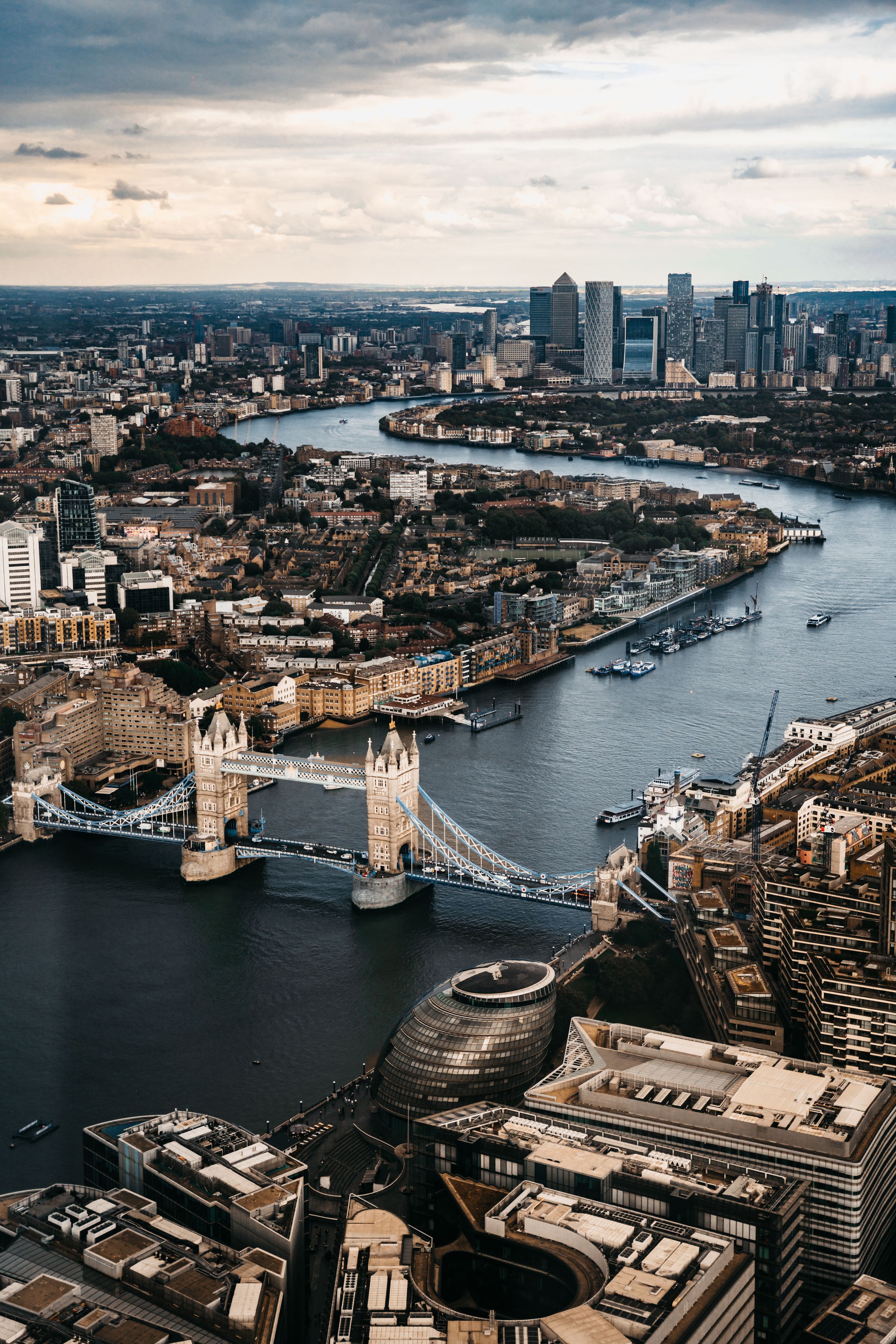 Aerial view of the River Thames curving around the Isle of Dogs, with the Canary Wharf skyline rising above the water
