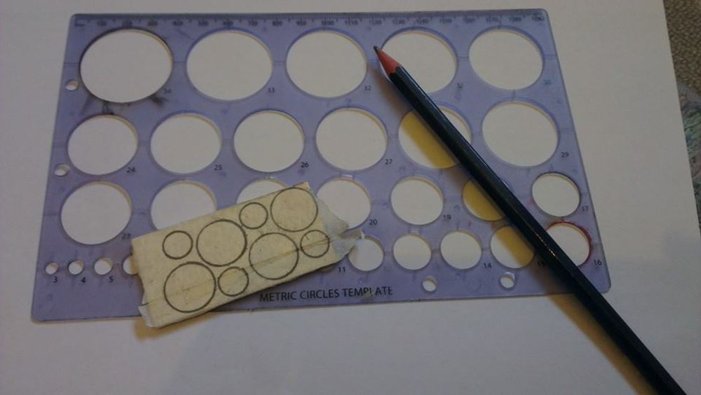 Circles drawn onto sheet of silver