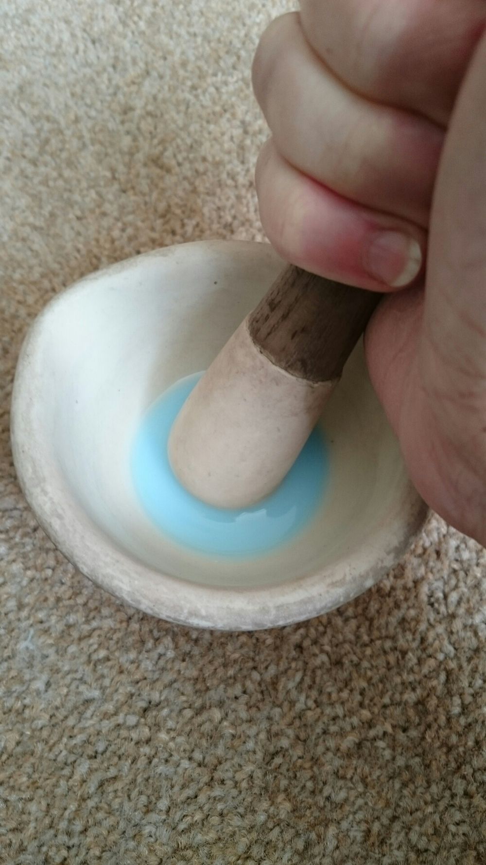 Enamel being prepared in a pestle and mortar