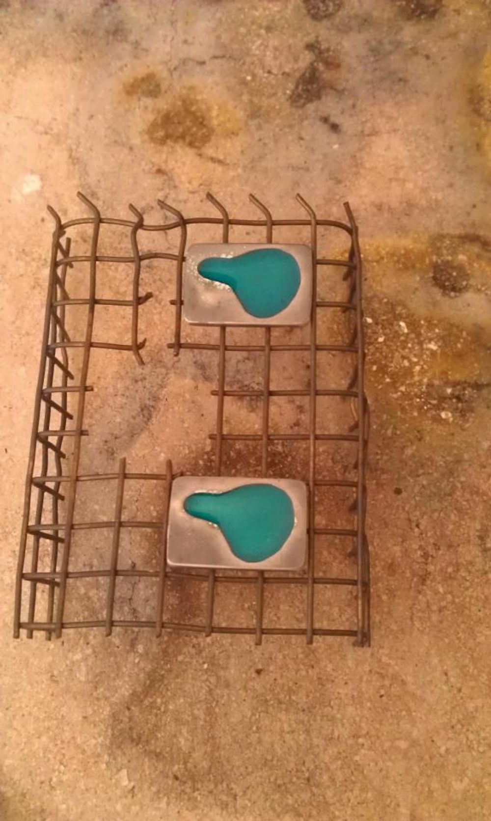 Enamelled pendants on wire rack cooling down