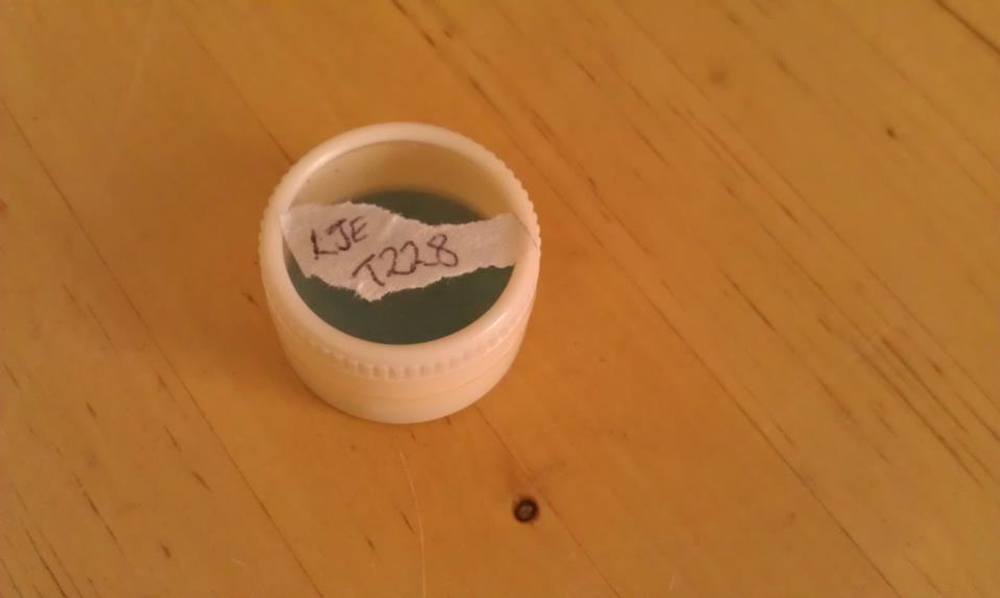 Powdered enamel in container with label "LJE T228"