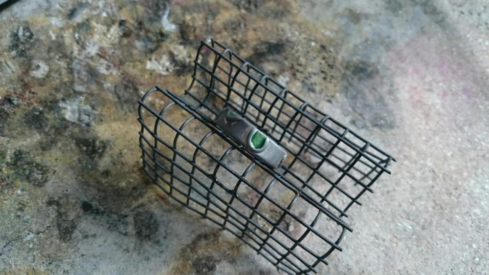 Silver ring with enamel sat on cooling rack