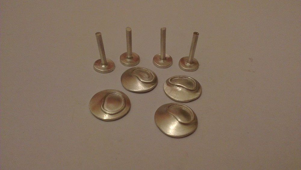 Bottom and top of cufflinks separate ready to be soldered together