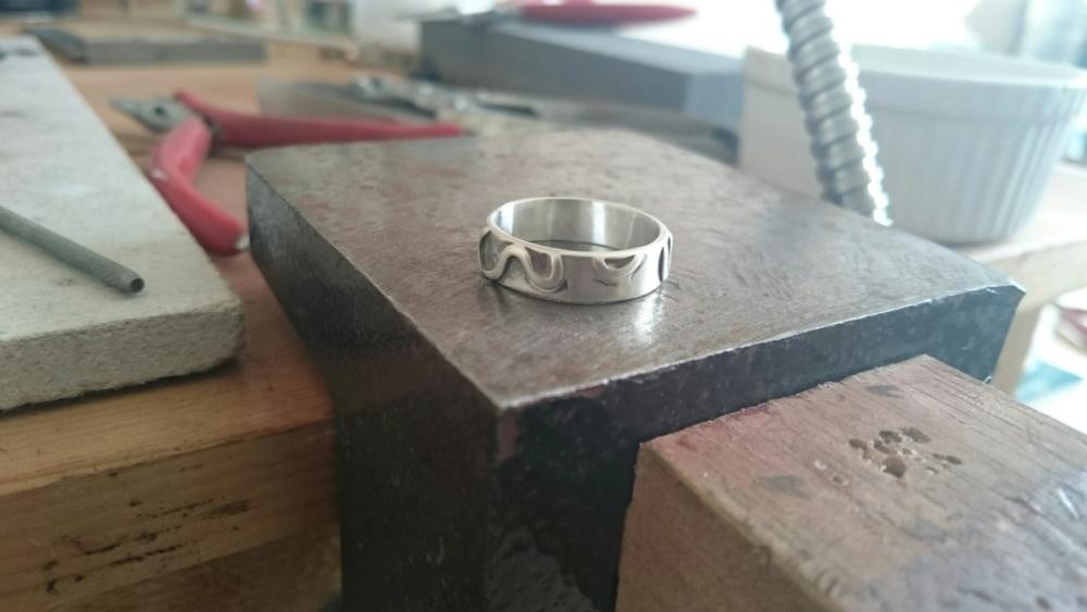 Silver ring say on workbench