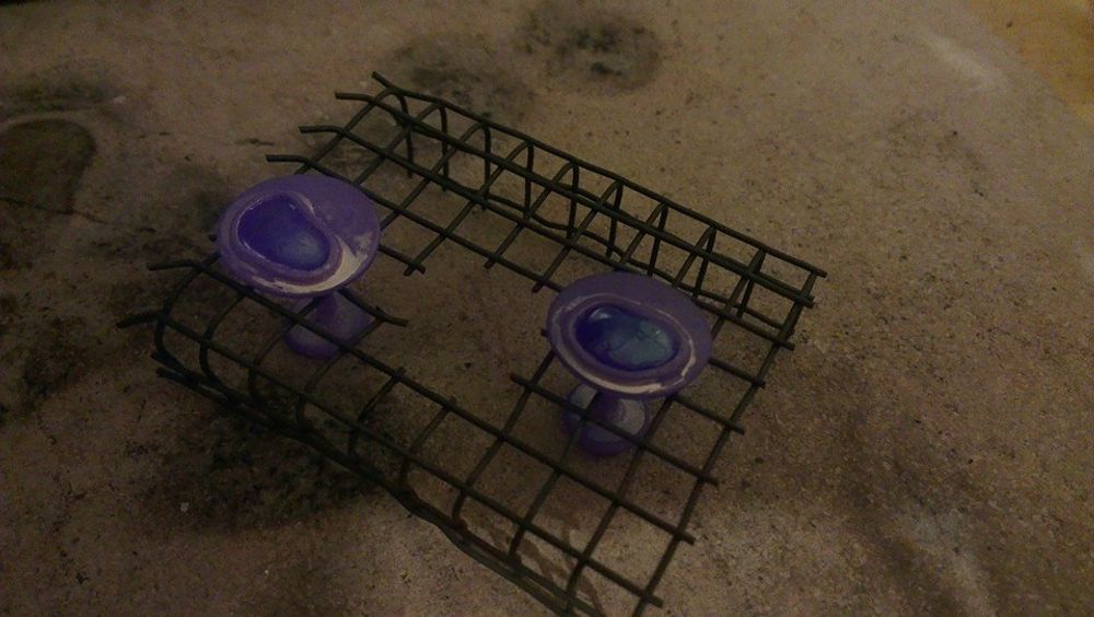 Silver cufflinks sat in wire cooling rack
