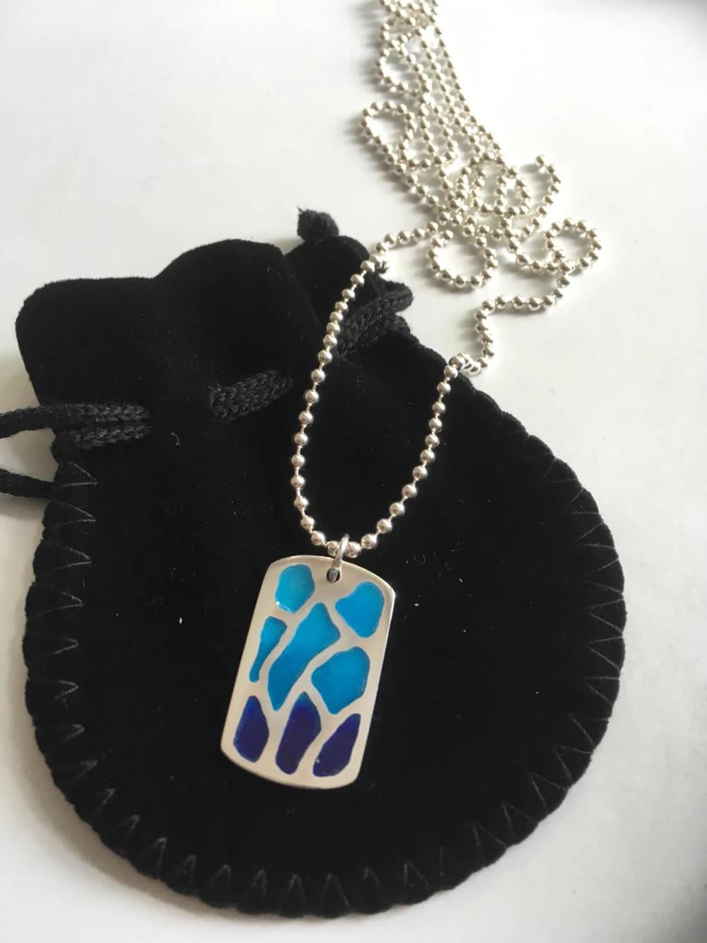 Silver dog tag pendant with dark to light blue gradient enamel and ball bearing style chain