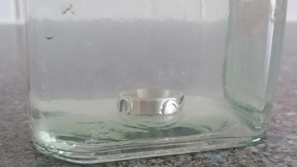 Silver ring in jar of safety pickle