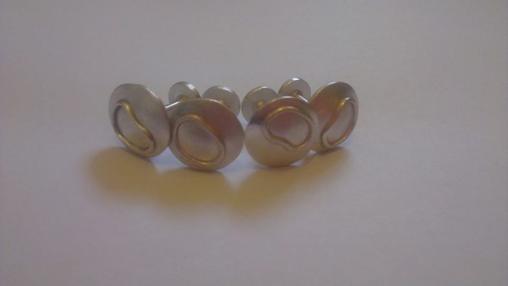 Bottom and top of cufflinks soldered together