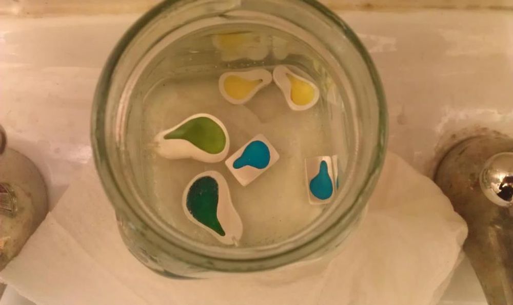 Pendants in jar of safety pickle