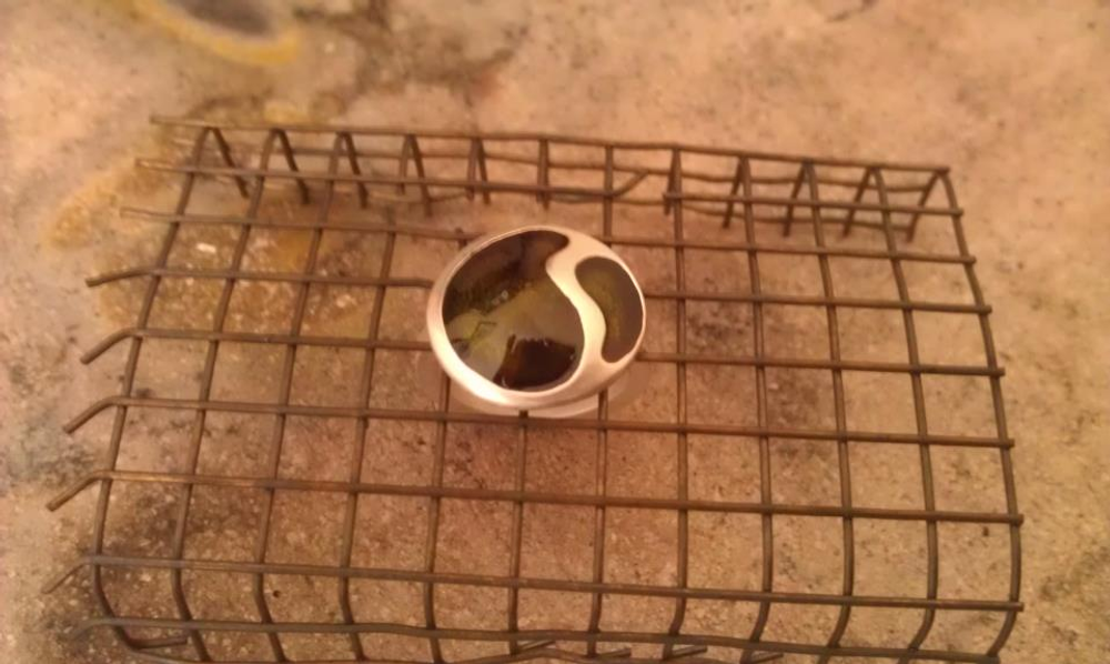 Silver ring cooling on wire rack after being fired after the second enamel coating