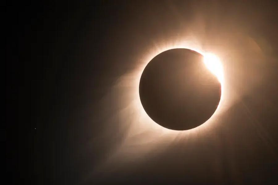 the sun hiding behind the moon during a partial eclipse