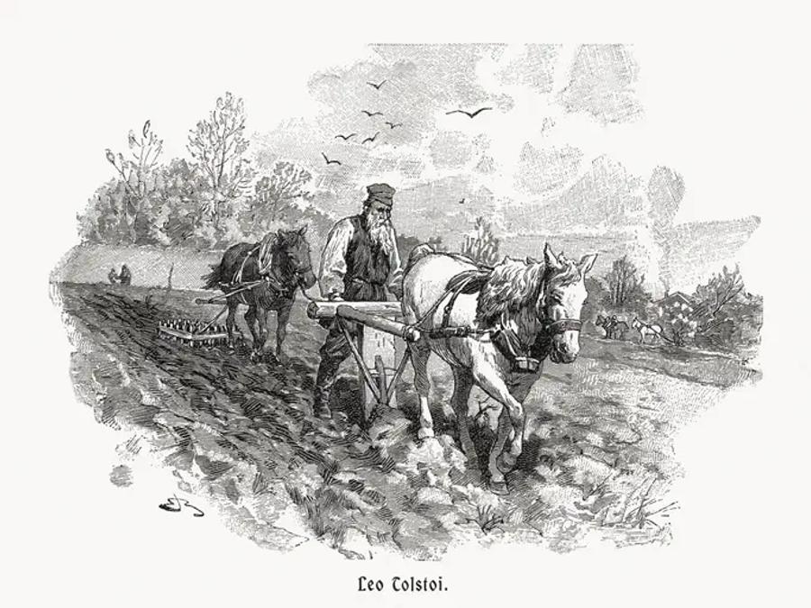 A black-and-white engraving of a bearded man in peasant clothes ploughing a field behind a white horse, with a second horse and a harrow behind him and birds flying overhead. A printed caption below reads "Leo Tolstoi."