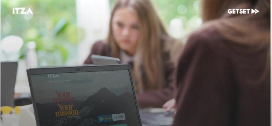 Teacher and student looking at a computer