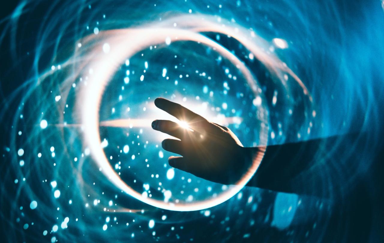 A hand touching a circle of lights