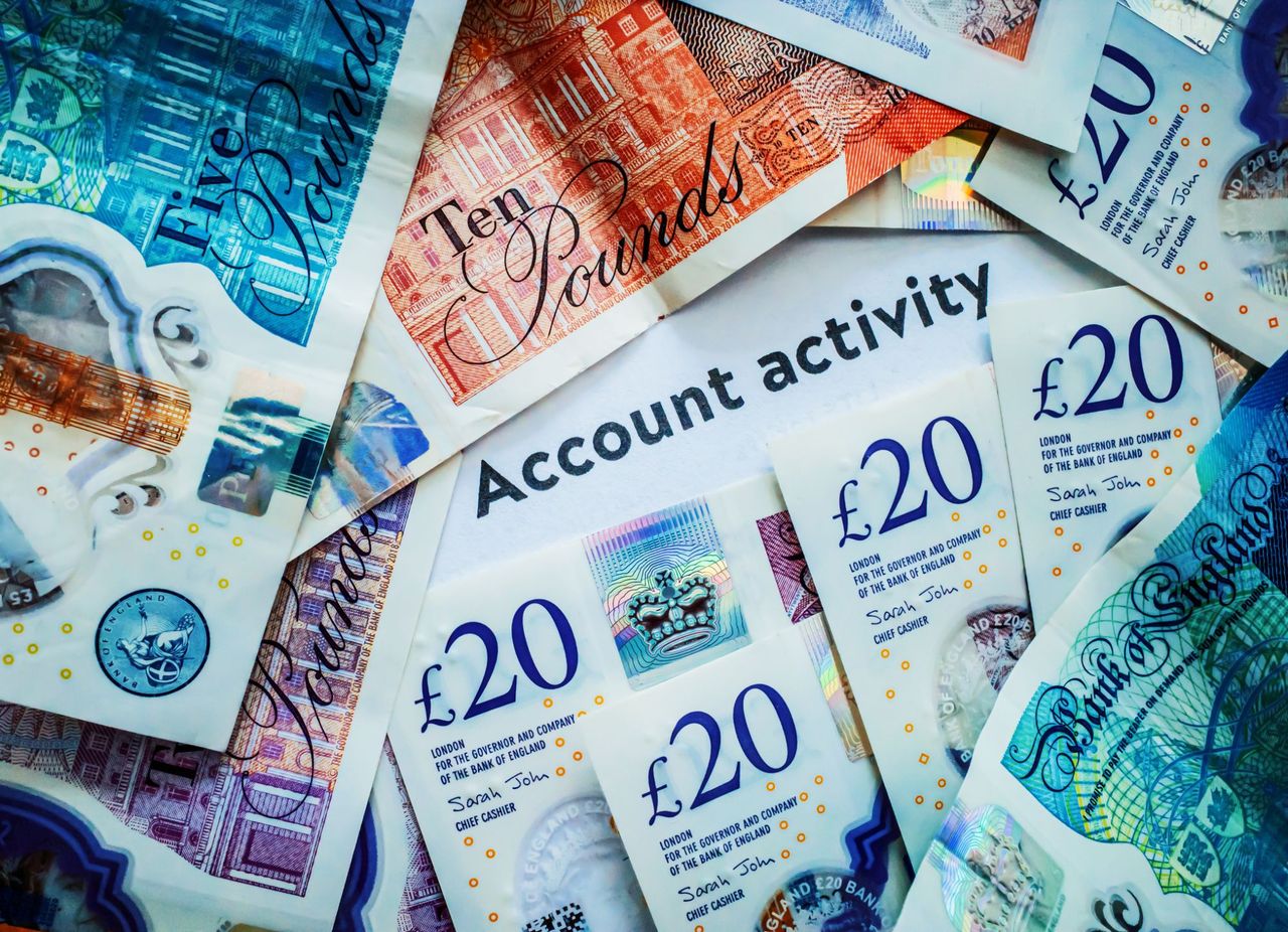 Words 'Account activity' surrounded by paper pound bills