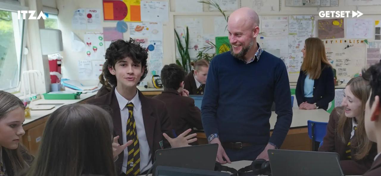 Students and teacher in the class using computers