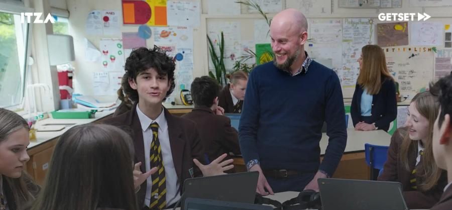 Students and teacher in the class using computers
