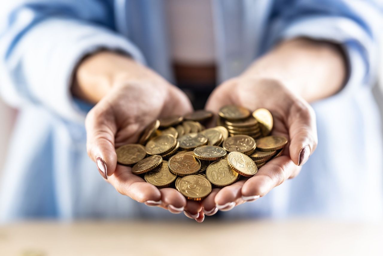 Woman holding a pile of euro coins in her hands